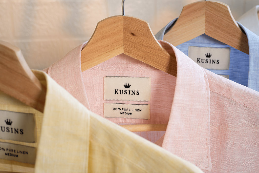 Blush / Pink shirt with Hangers with Kusins linen shirts and labels in a store setting