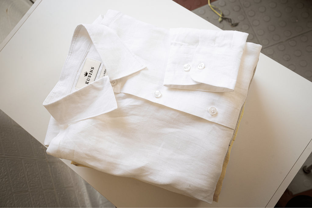 chalk or White shirt with tags on a white surface