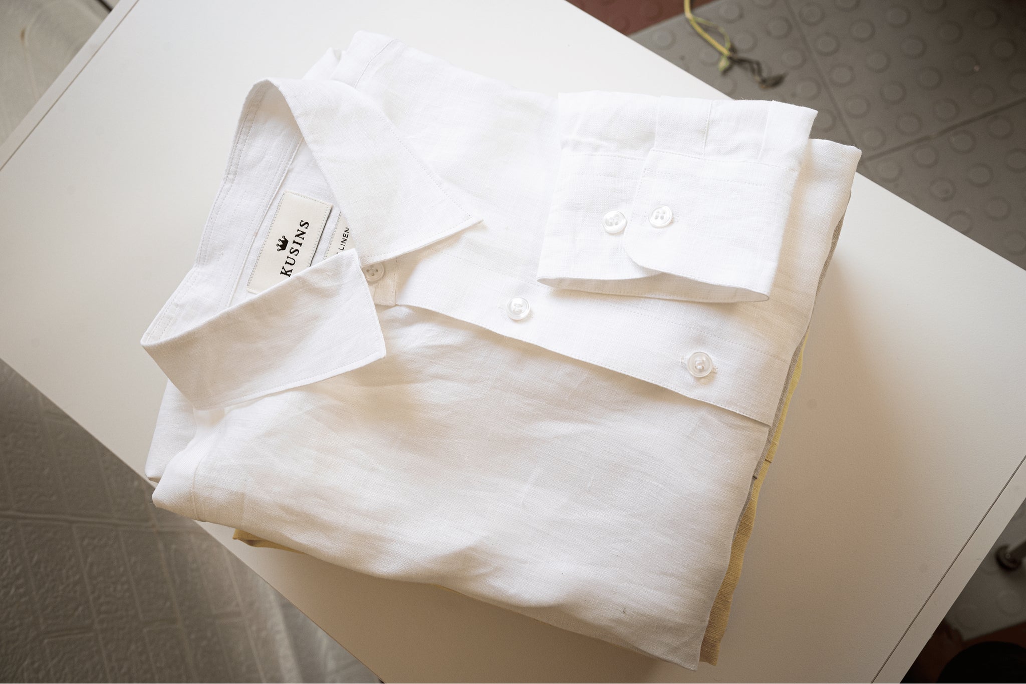 chalk or White shirt with tags on a white surface