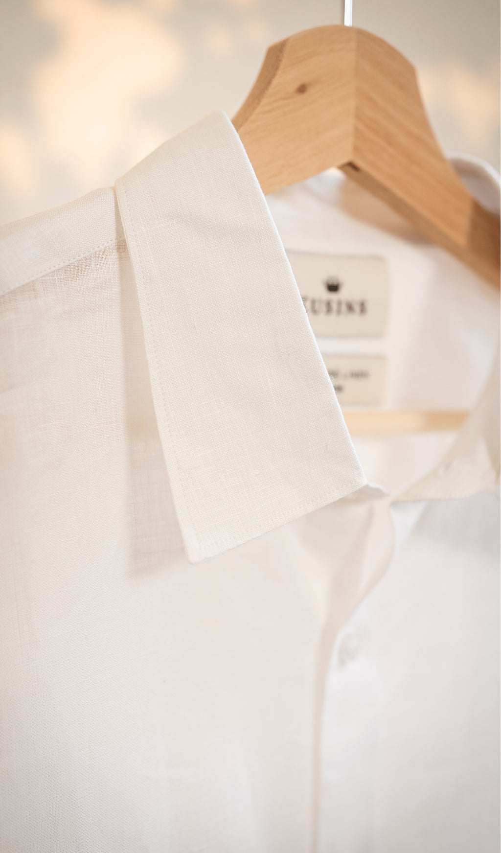 chalk or White shirt on a wooden hanger with blurred background